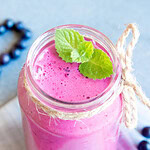 Colourful smoothie in a glass with berries